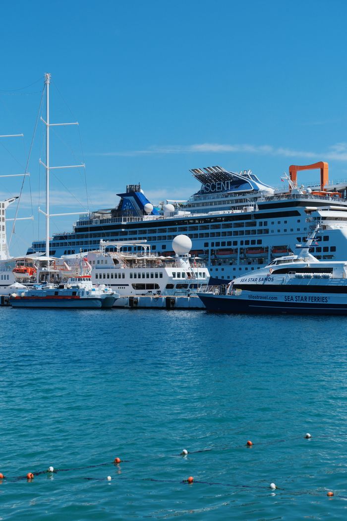 creative-03 Vibrant cruise ships docked at a sunny port, ideal for travel and vacation themes.